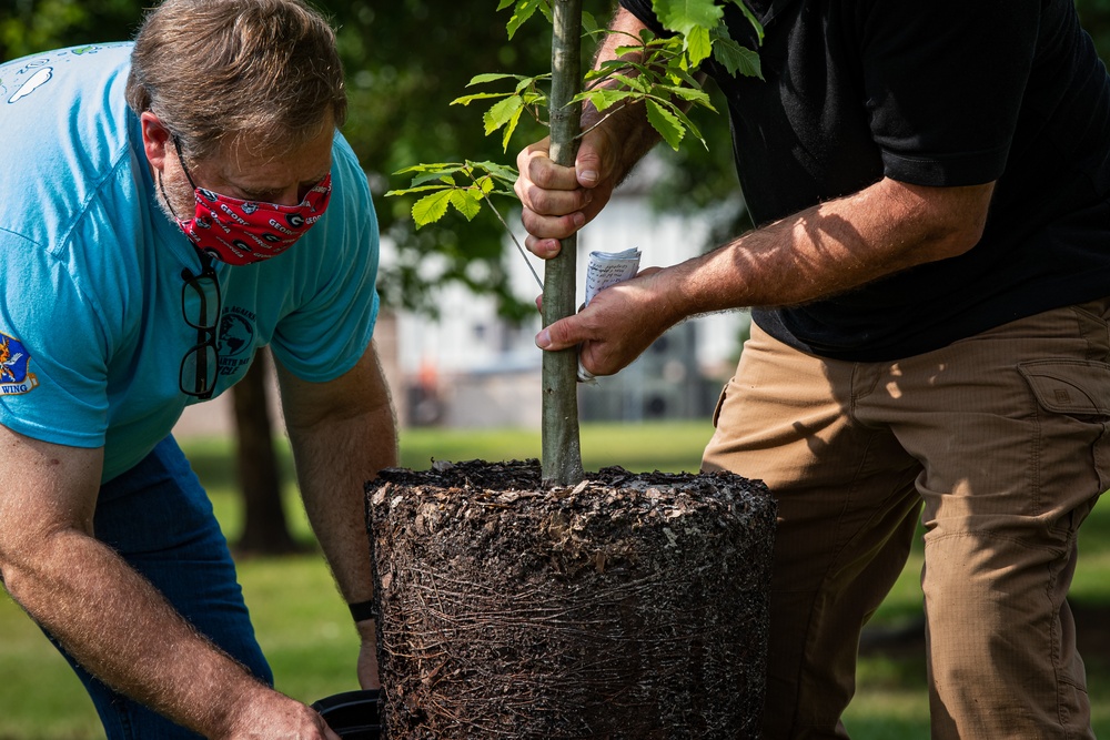 Airmen, children plant tree for Arbor Day