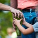 Airmen, children plant tree for Arbor Day