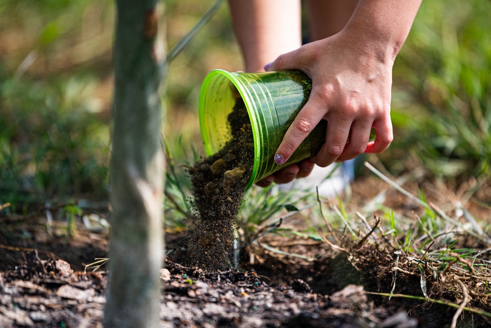 Airmen, children plant tree for Arbor Day