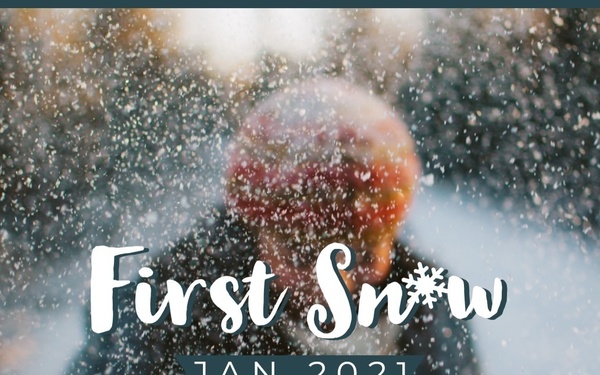 A decorative photo composition showing a person outdoors during a snowfall, overlaid with stylized text reading 'First Snow' and 'JAN 2021'. The subject is wearing a dark coat and a red/orange winter hat, with arms slightly outstretched, facing away from the camera. The image appears to be a memory or scrapbook-style graphic commemorating a first snowfall event.