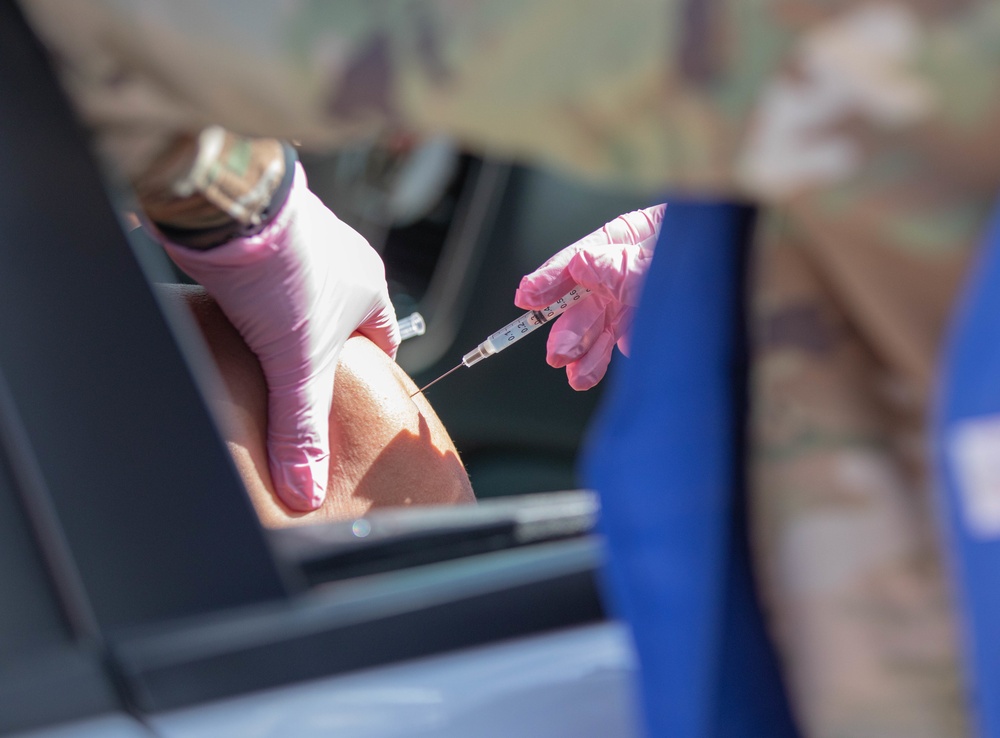 2nd Stryker Brigade Combat Team, 4th Infantry Division Soldiers vaccinate members of the Pueblo community