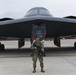 Security Forces Defender Airman 1st Class Elijah R. Posana stands in front of B-2 Spirit