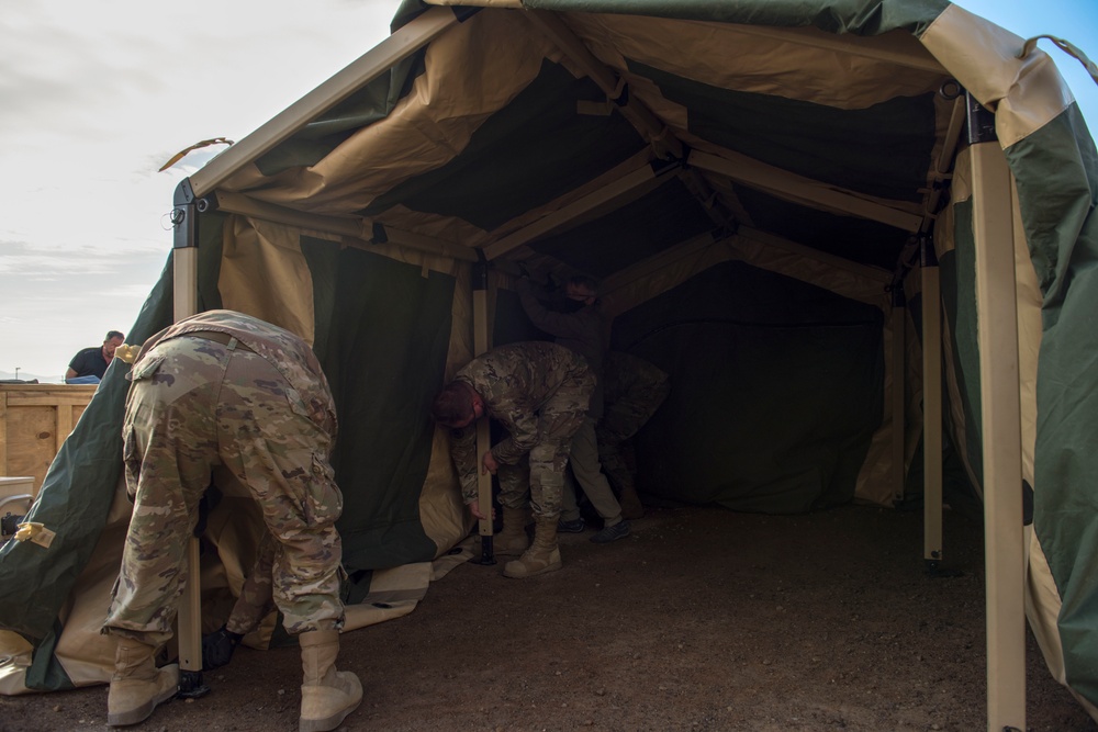 Airmen build a collective protective shelter