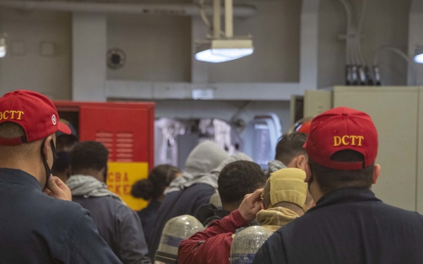 USS America (LHA 6) Sailors fight a simulated fire.