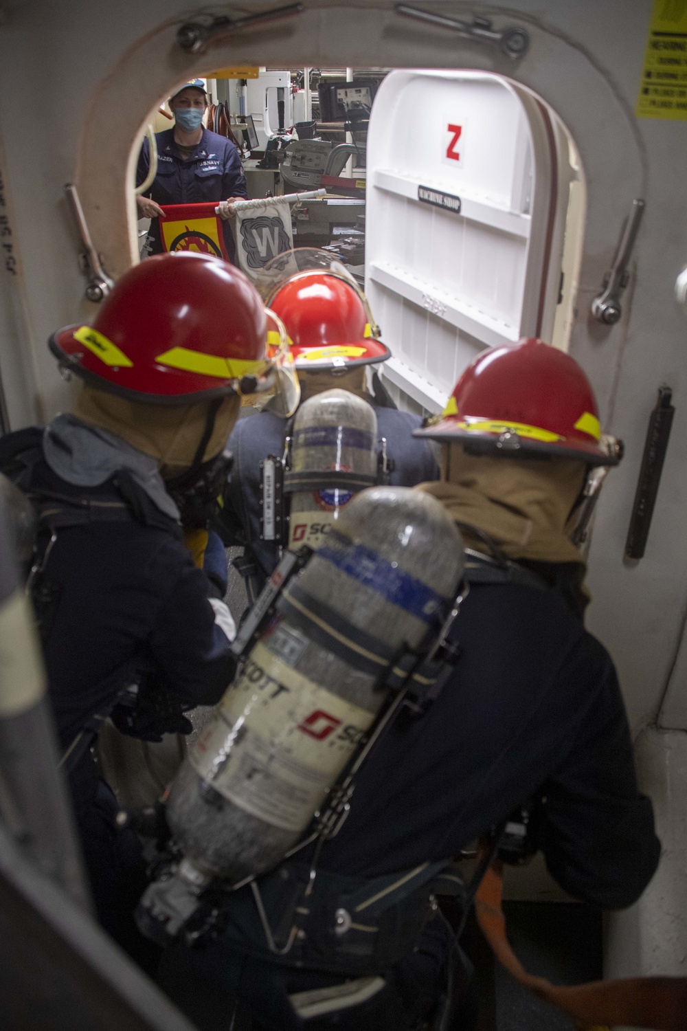 USS America (LHA 6) Sailors fight a simulated fire.