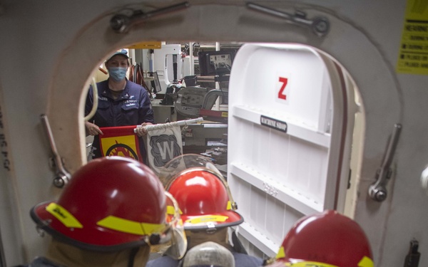 USS America (LHA 6) Sailors fight a simulated fire.