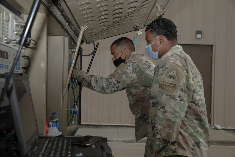 U.S. Army Soldiers spearhead communications setup for a tactical operations center.