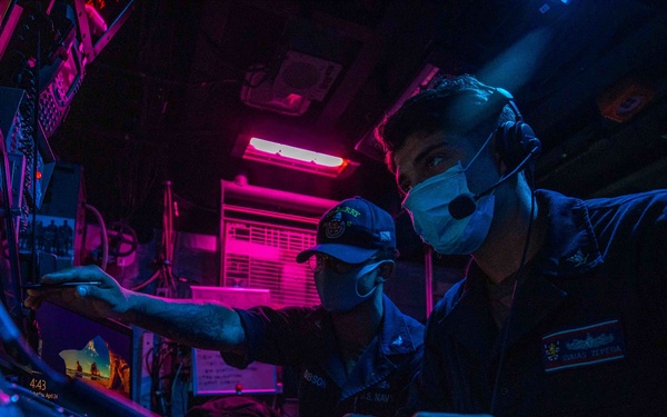 CTT2 Brandon Gibson and CTT3 Isais Zepeda stand the Electronic Warfare Supervisor watch aboard the USS Barry