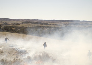 Camp Guernsey prepares for fire season with prescribed burn and bucket drop exercise