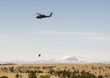 Camp Guernsey prepares for fire season with prescribed burn and bucket drop exercise