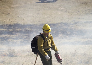 Camp Guernsey prepares for fire season with prescribed burn and bucket drop exercise
