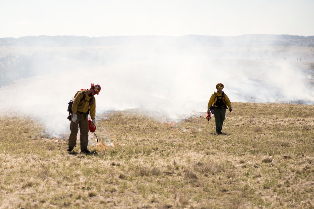 Camp Guernsey prepares for fire season with prescribed burn and bucket drop exercise