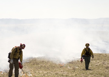 Camp Guernsey prepares for fire season with prescribed burn and bucket drop exercise