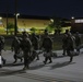 Paratroopers exit Pax Shed to load C-17