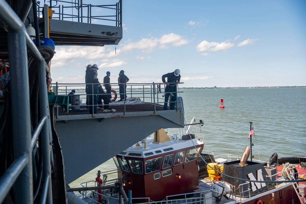 Sailors observe a tug boat