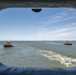 Tugs boats follow the Stennis