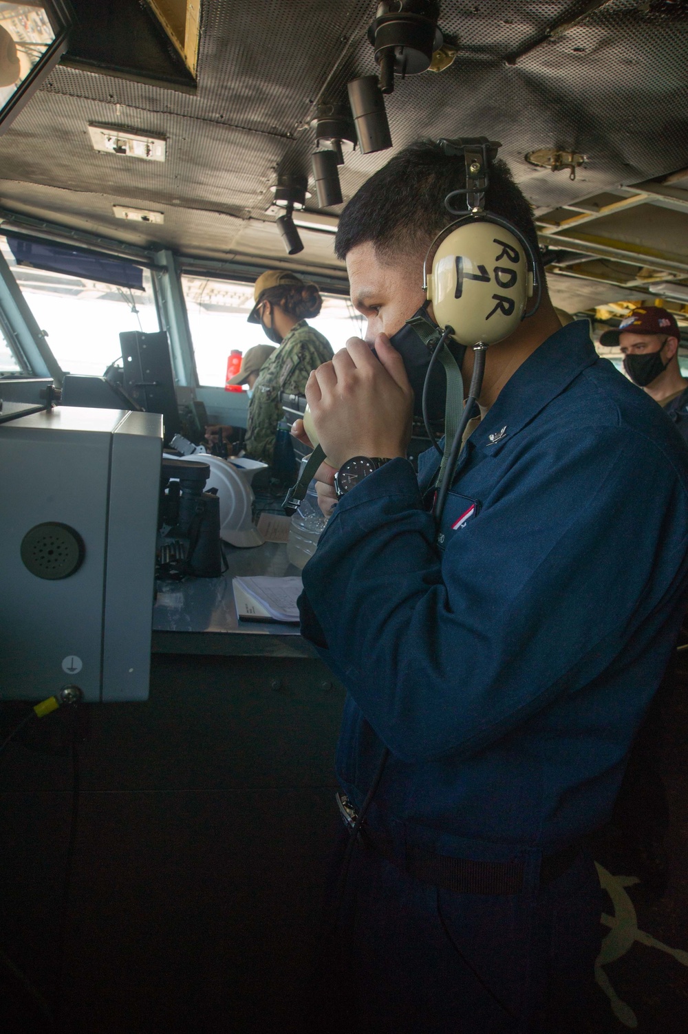 Sailor tests communication system equipment.