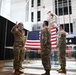 Staff Sgt. Chase Warren reenlists at the Michael Jordan statue at the United Center COVID-19 Community Vaccination Center, Chicago