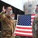 Staff Sgt. Chase Warren reenlists at the Michael Jordan statue at the United Center COVID-19 Community Vaccination Center, Chicago