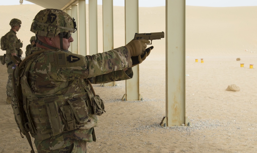 Command Sgt. Maj. Jim Horn, 36th Infantry Division, Task Force Spartan, shoots after TF Spartan small arms marksmanship competition