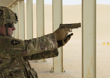 Command Sgt. Maj. Jim Horn, 36th Infantry Division, Task Force Spartan, shoots after TF Spartan small arms marksmanship competition