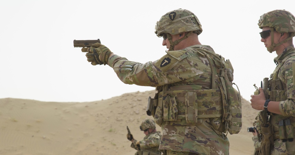 Maj. Gen. Patrick Hamilton, commanding general of 36th Infantry Division, Task Force Spartan, shoots the SIG Sauer M17 with the winners of TF Spartan 2nd Annual Small Arms Marksmanship Competition