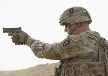 Maj. Gen. Patrick Hamilton, commanding general of 36th Infantry Division, Task Force Spartan, shoots the SIG Sauer M17 with the winners of TF Spartan 2nd Annual Small Arms Marksmanship Competition