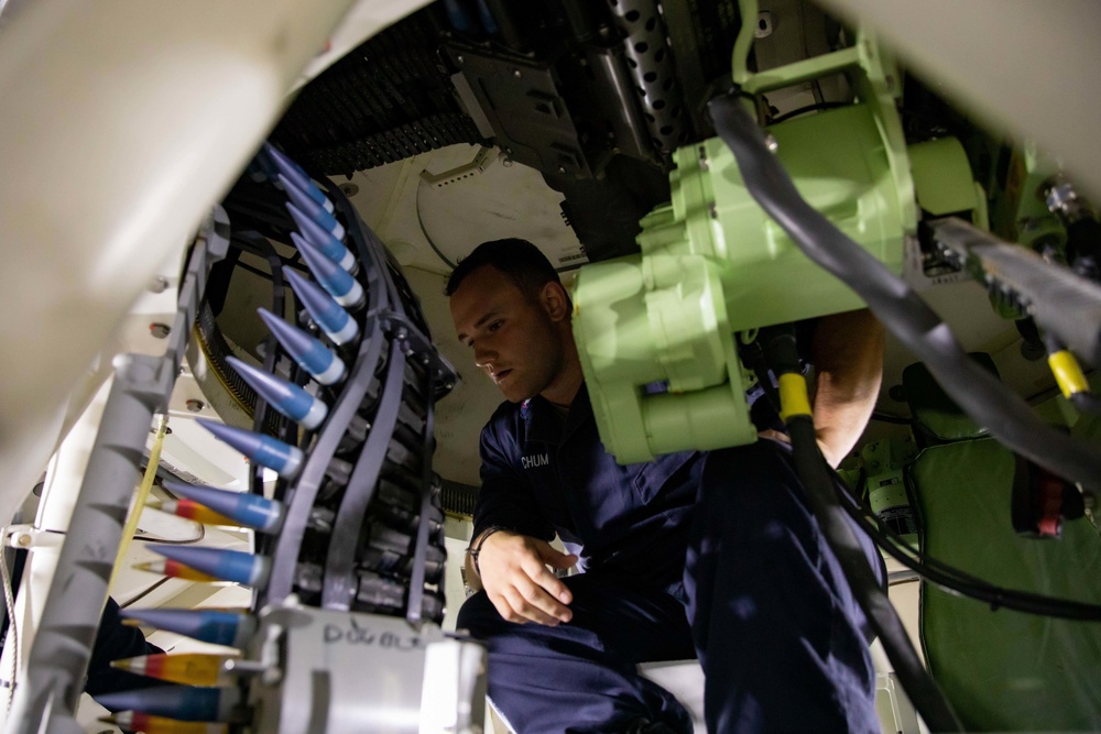 U.S. Navy Sailor Loads a 30mm Gun Aboard USS Sioux City