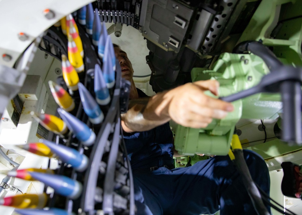 U.S. Navy Sailor Loads a 30mm Gun Aboard USS Sioux City