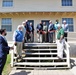 Retired Col. Mike Weaver cuts ribbon at WWII barracks grand opening