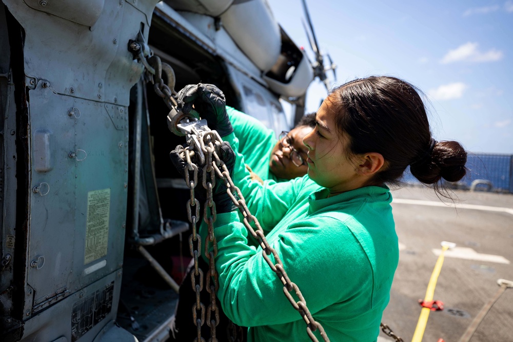 U.S. Navy Sailors Assigned to USS Sioux City and HSC 22 Chock and Chain Helicopter