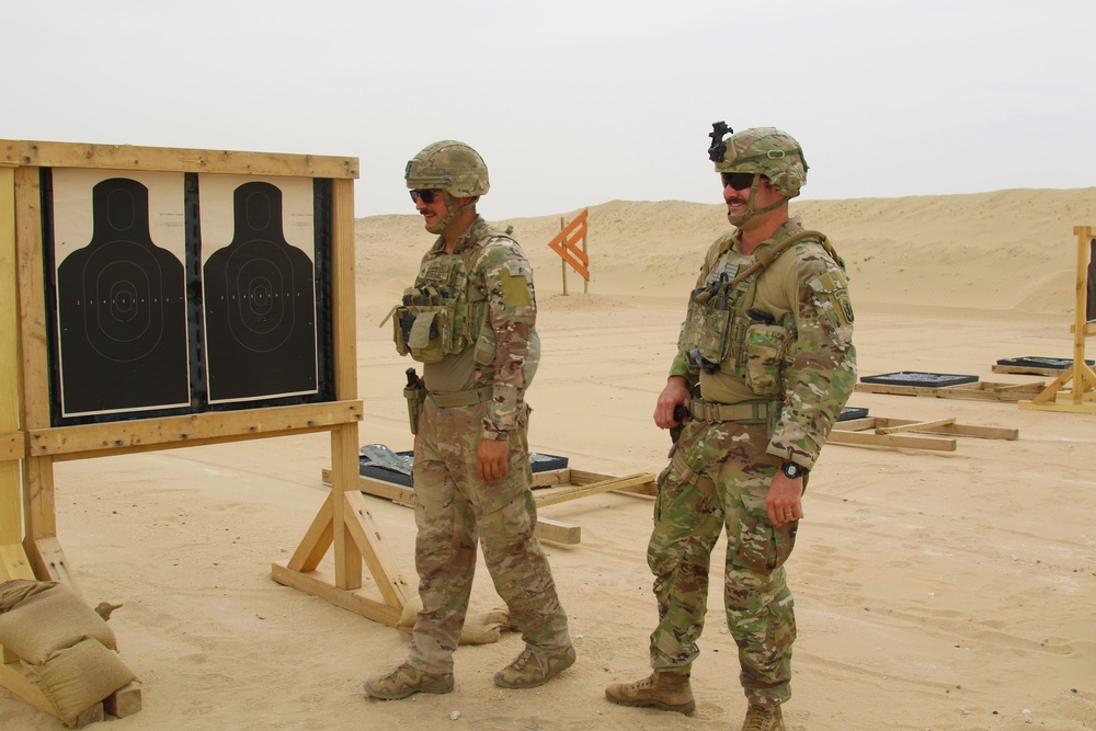 Task Force Spartan Soldiers share a moment of comradery at small arms competition