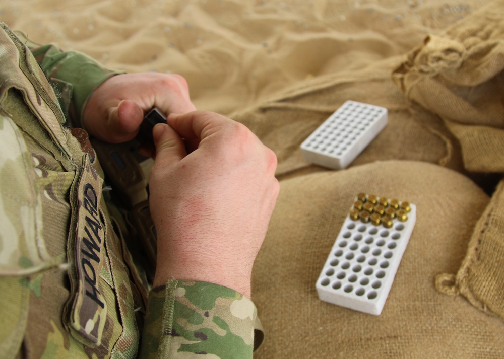 A Task Force Spartan Soldier loads magazine for SIG SAUER M17 during TF Spartan small arms competition