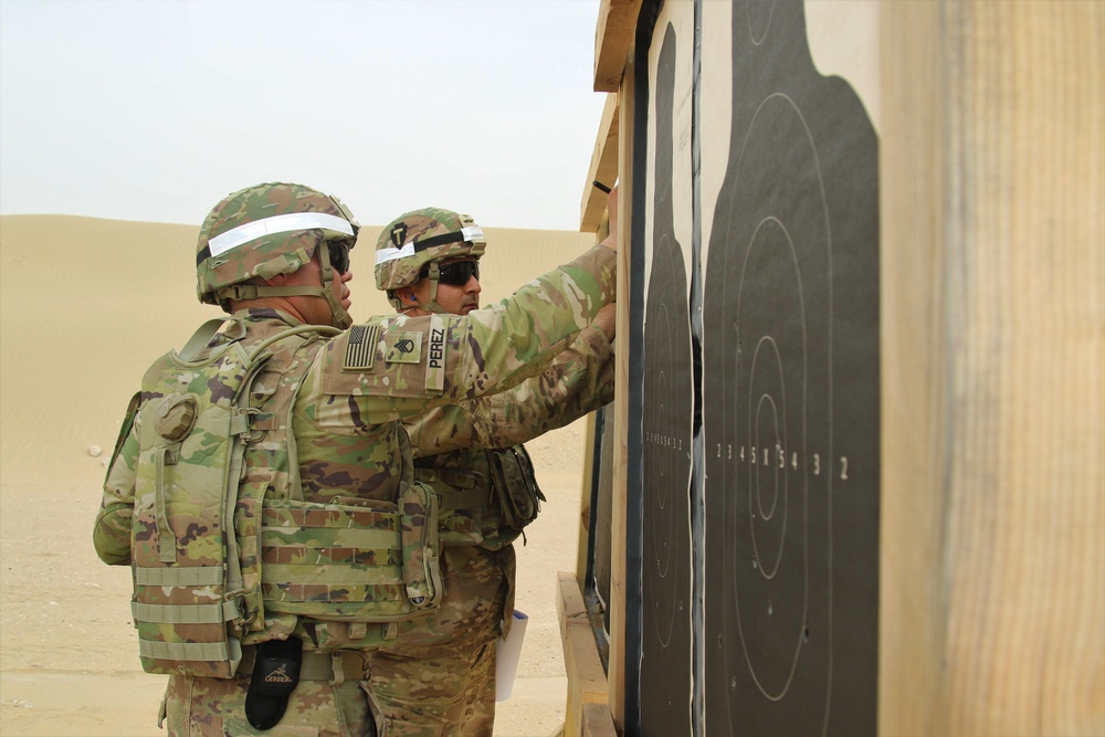 Task Force Spartan Soldiers check targets after firing at small arms competition