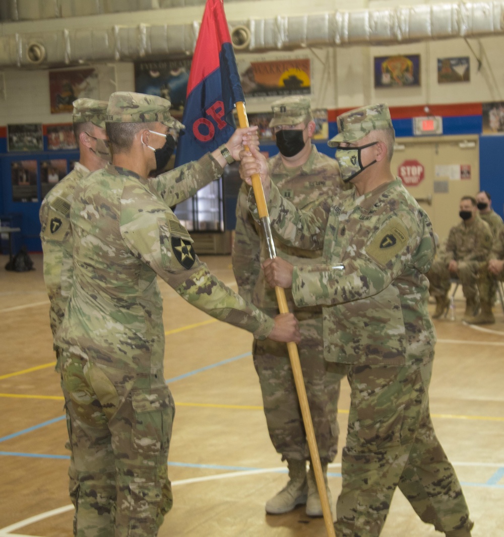 1st Sgt. Abel Nasser passes guidon to outgoing command at change of command
