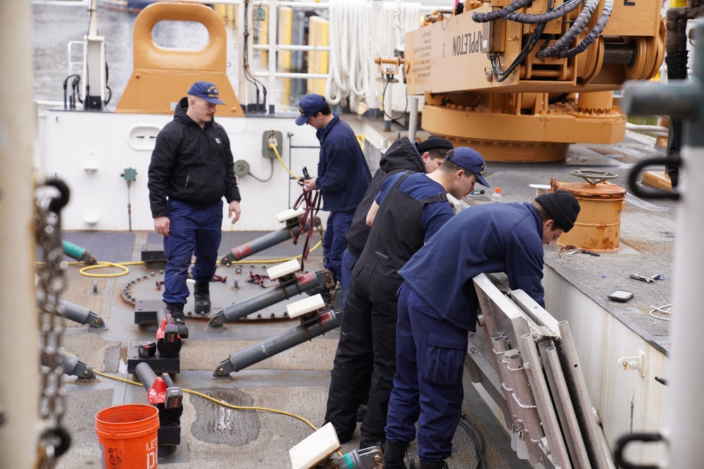 Coast Guard Cutter Stratton crew members conduct deck maintenance