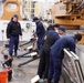Coast Guard Cutter Stratton crew members conduct deck maintenance
