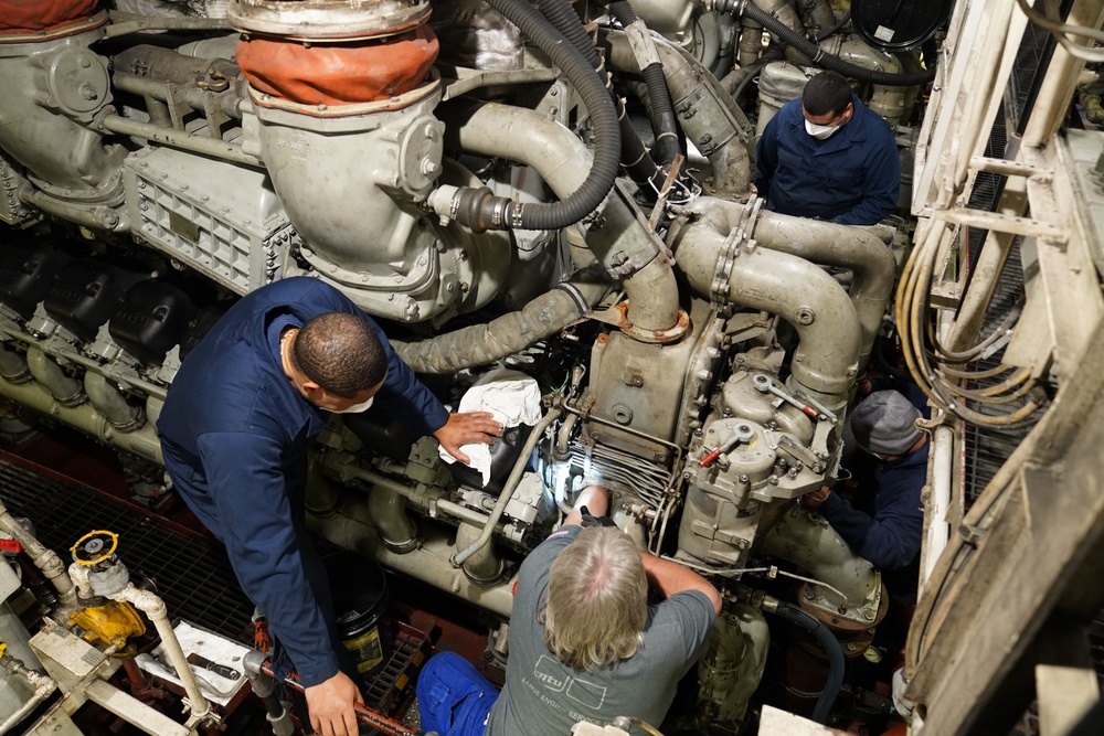 Coast Guard Cutter Stratton machinery technicians conduct engine maintenance