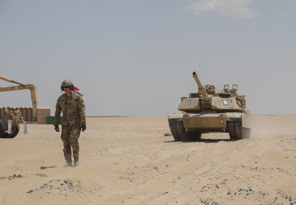 U.S. Army Capt. Michael Bogda, 3rd platoon leader, 1st Battalion, 194th Armor Regiment, leads a M1 Abrams Main Battle Tank to the ammunition point