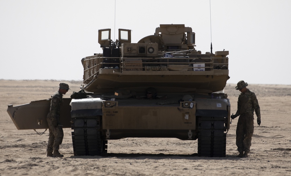 U.S. Army Sgt. Justin Rose and U.S. Army Spc. Bailey Flonn, assigned to 1st Battalion, 194th Armor Regiment, make minor adjustments on their M1 Abrams Main Battle Tank tracks