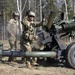 Soldier tosses an empty 105 mm shell