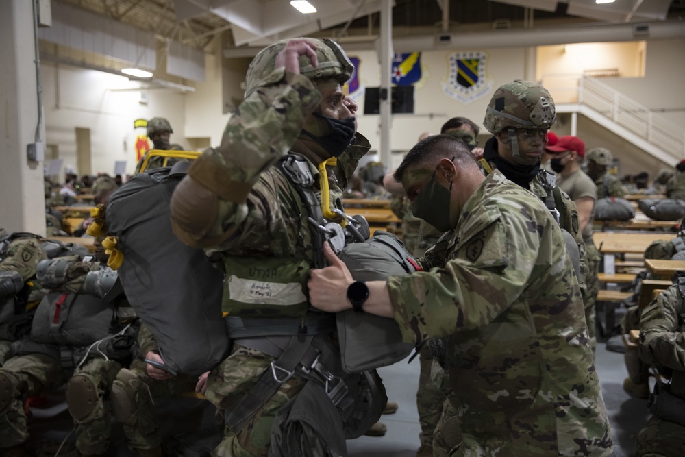 Master Sgt. Clinton McMarlin inspects soldier's gear before jump