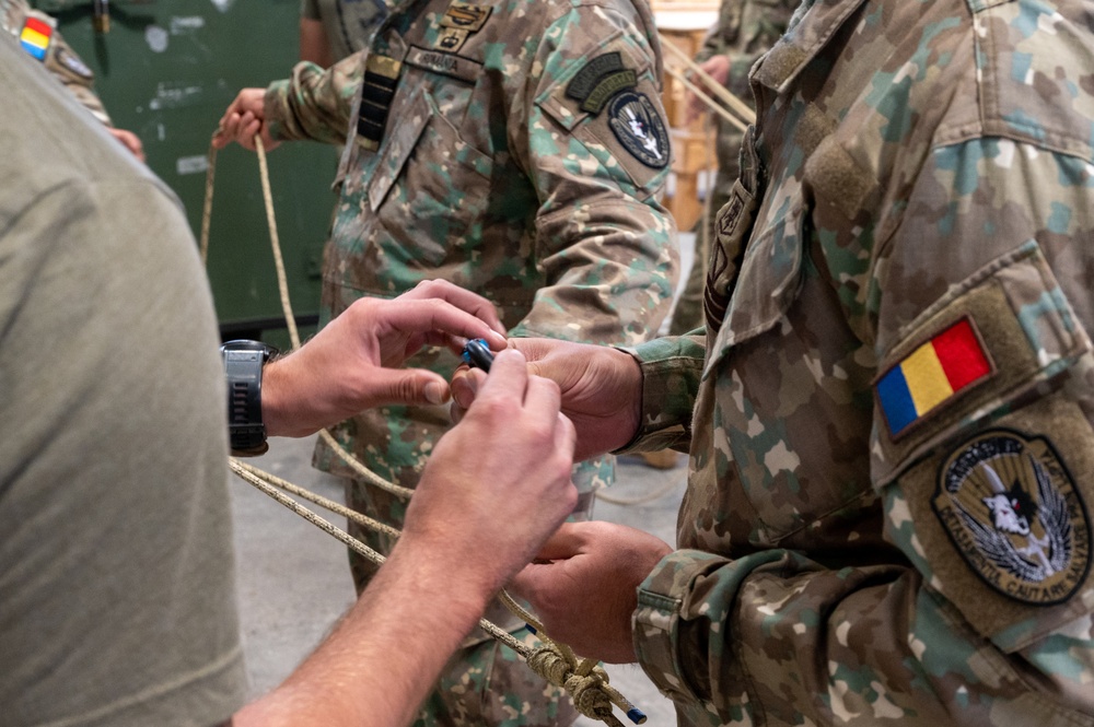 U.S. Air Force Special Operations Forces train with Romanian DCSL on knots and ropes.