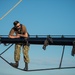 USS Constitution Sailors climb the mizzen top yard