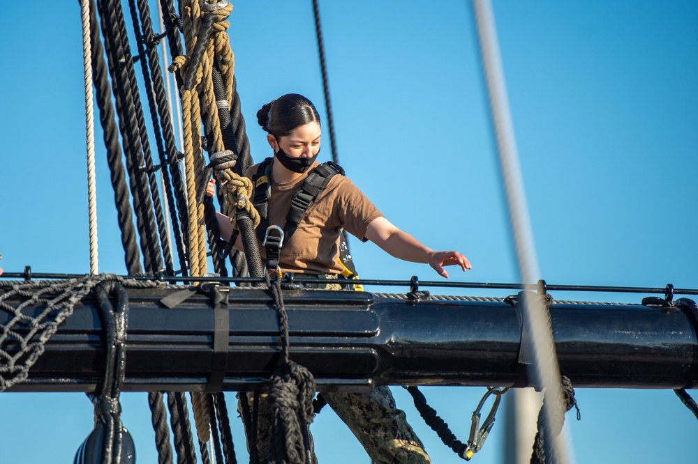 USS Constitution Sailors climb the mizzen top yard