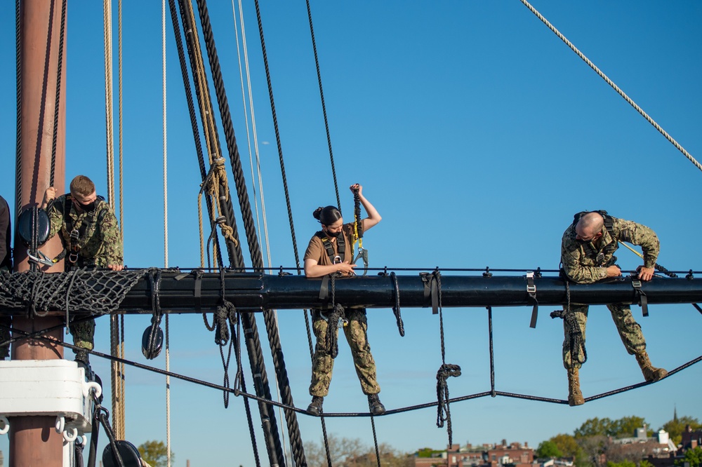 USS Constitution Sailors climb the mizzen top yard