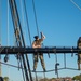 USS Constitution Sailors climb the mizzen top yard