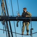 USS Constitution Sailors climb the mizzen top yard