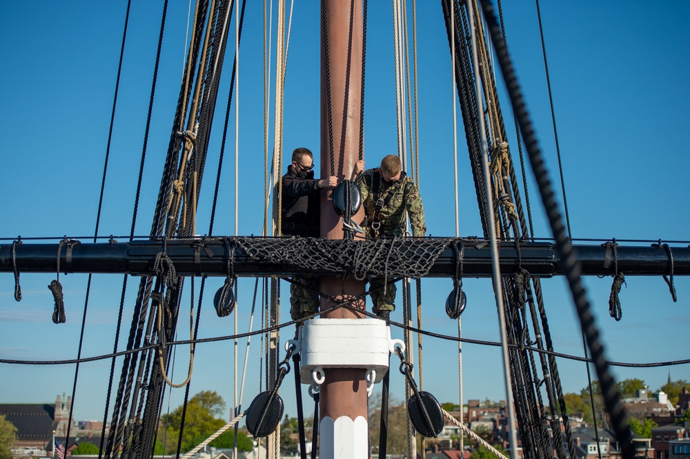 USS Constitution Sailors climb the mizzen top yard