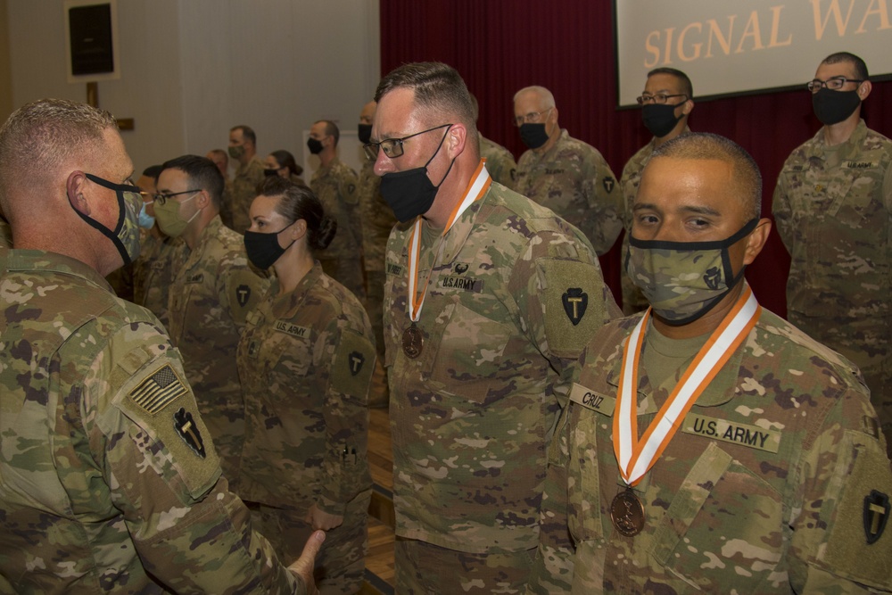 U.S. Army Sgt. 1st Class Reuben Cruz and U.S. Army Maj. Henrich DuPreez, signal Soldiers from 36th Infantry Division, Task Force Spartan, receive Bronze Order of Mercury